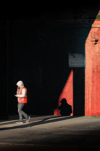 Worker walking through light street photography